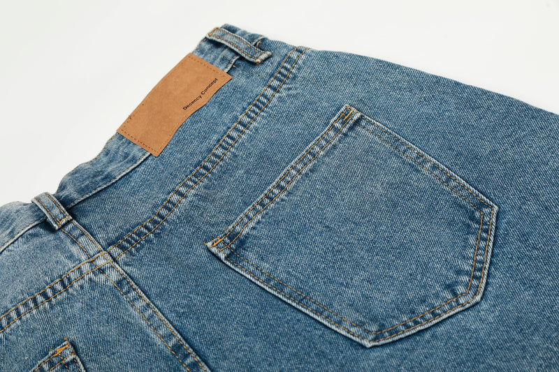 Close-up of back right pocket on blue denim jeans with tan label