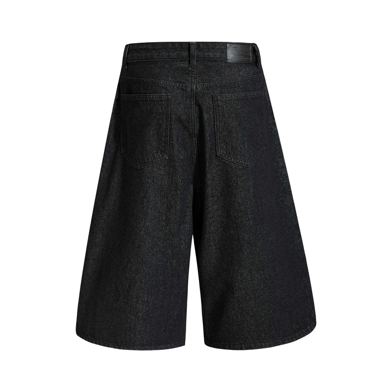 Back view of black denim shorts with wide legs and back patch pockets