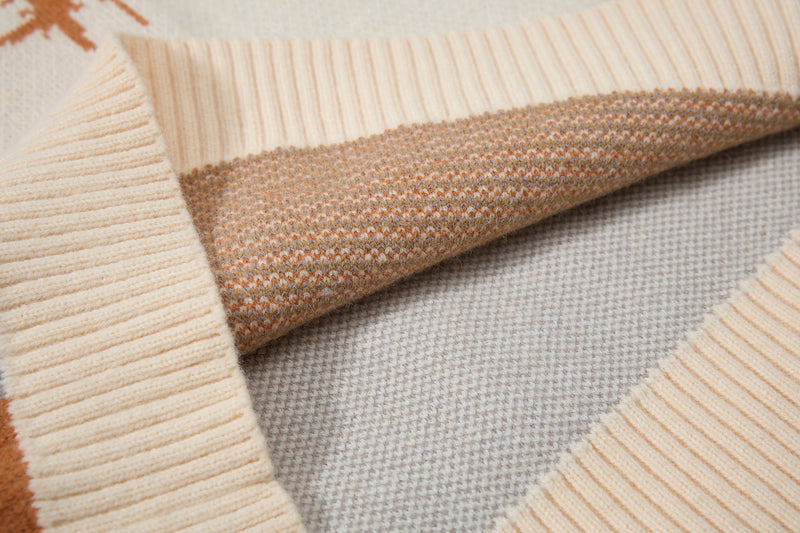 Close-up of sleeve and ribbed cuff on tan and cream colorblock knit sweater