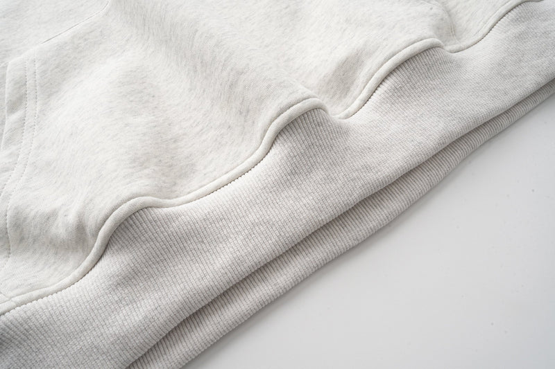 Ribbed hem and lower front of light gray oversized hoodie