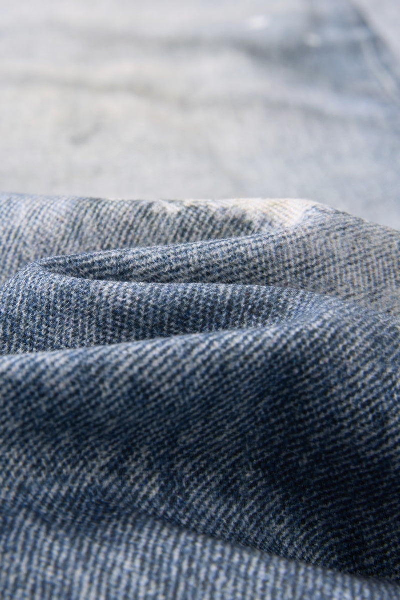 Close-up of dark blue denim waistband texture with layered jeans fabric
