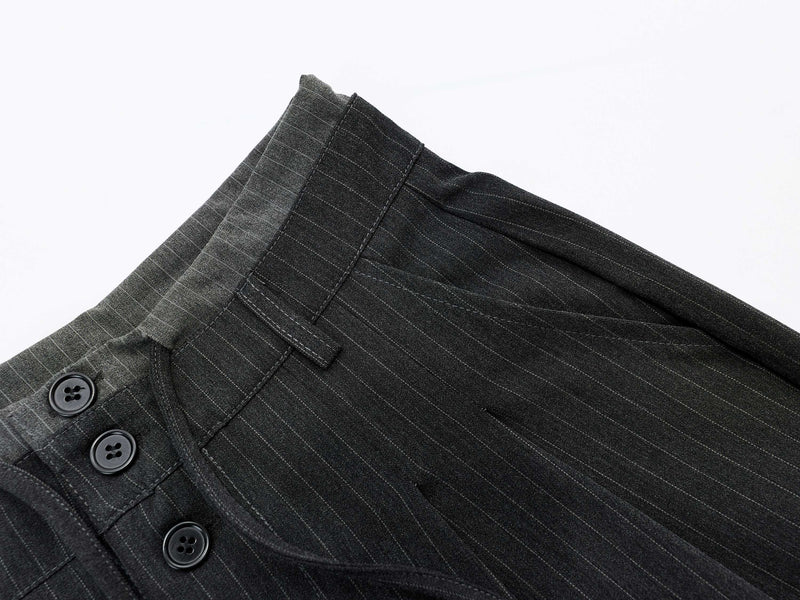 Close-up of charcoal pinstripe shorts waistband and front button detail