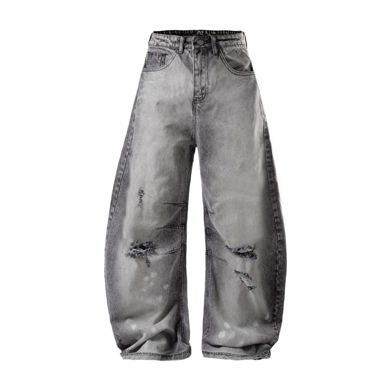 Front view of washed gray baggy jeans with distressed knees and wide legs