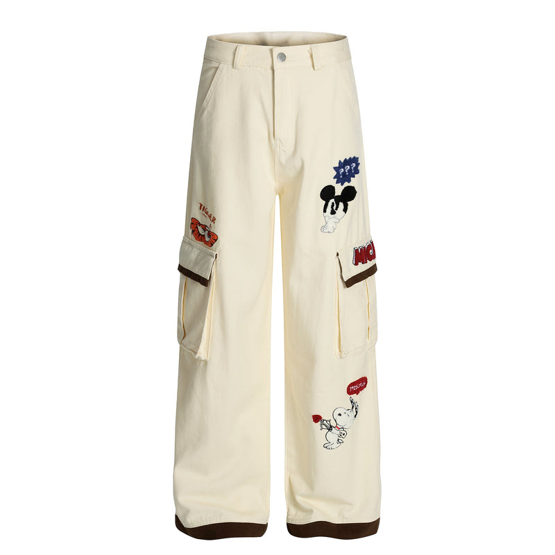 Cream cargo trousers with cartoon patches and flap pockets, front view
