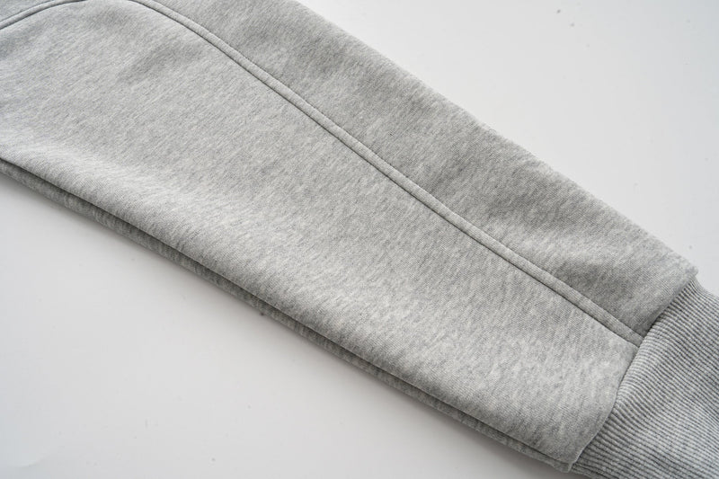 Close-up of heather grey hoodie sleeve with straight seam and ribbed cuff