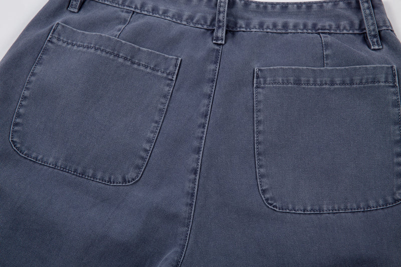 Back pocket close-up on blue barrel-cut denim pants