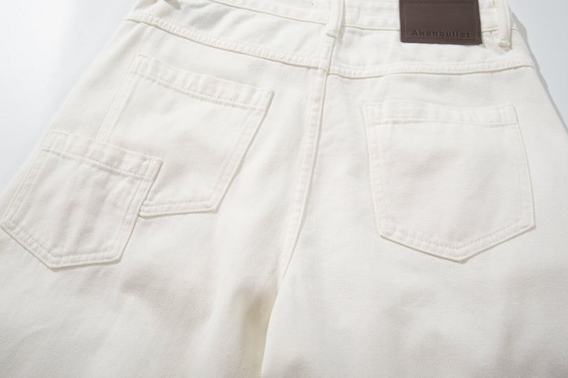 Back view close-up of white jeans showing both patch pockets and waistband label