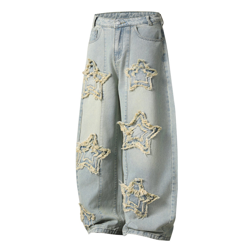 Three-quarter front view of light wash wide-leg jeans with frayed star patches