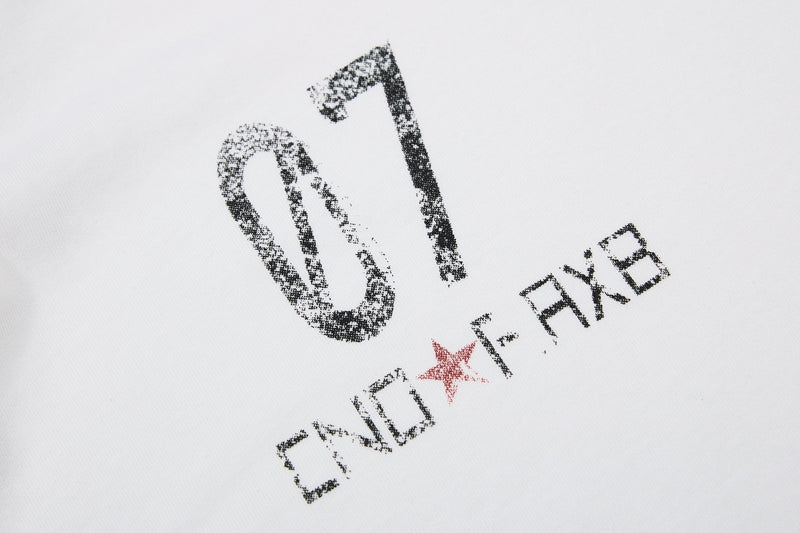 White polo shirt with distressed black OXYR graphic and red star, vintage music-inspired streetwear print