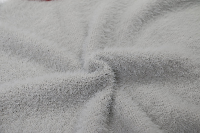 Close-up of white fuzzy sweater fabric texture