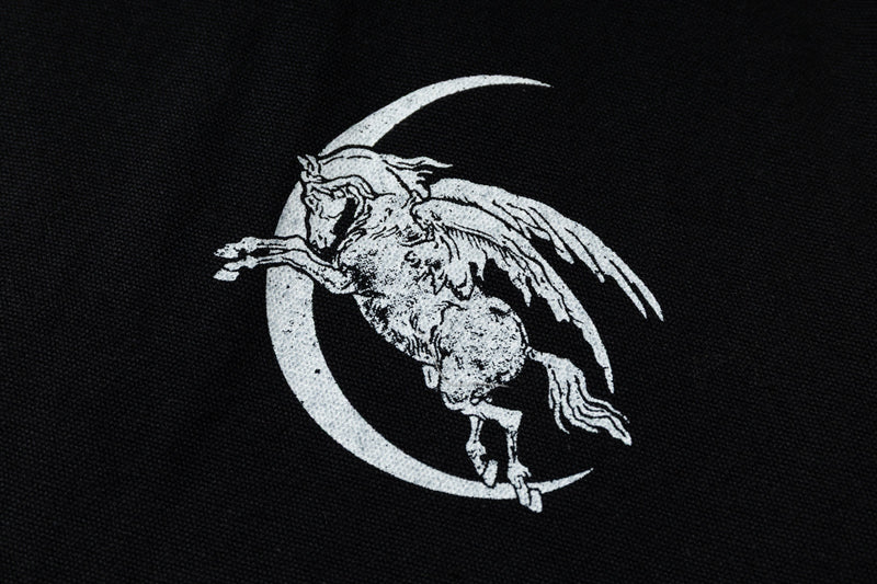 Close-up of white graphic print on black hoodie front