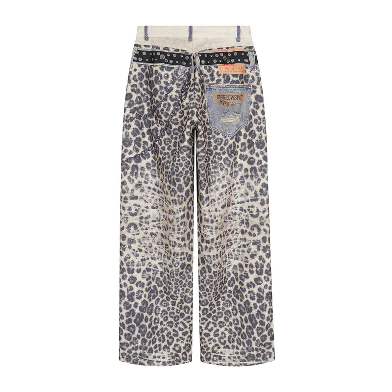 Back view of leopard print wide-leg pants with patch pockets, chain detail, and denim patchwork waistband