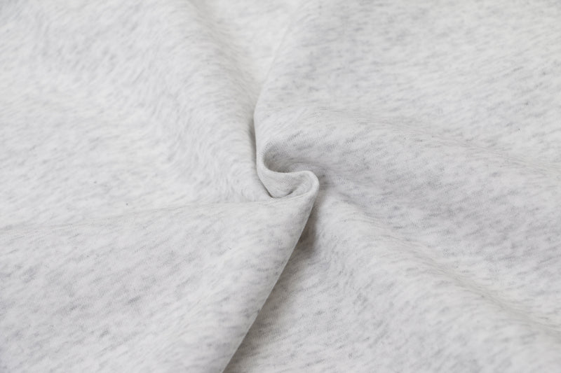 Close-up of light gray hoodie fabric texture and gathered fold