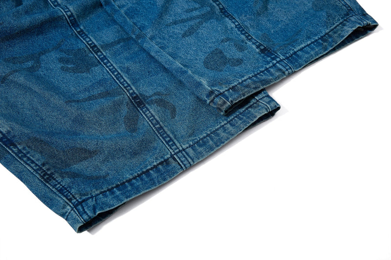Close-up of hem and lower leg on washed blue camo baggy jeans