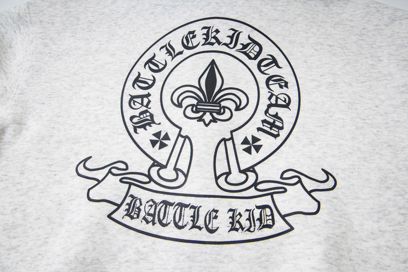 Close-up of back crest graphic on white hoodie with fleur-de-lis and Battle Kid banner