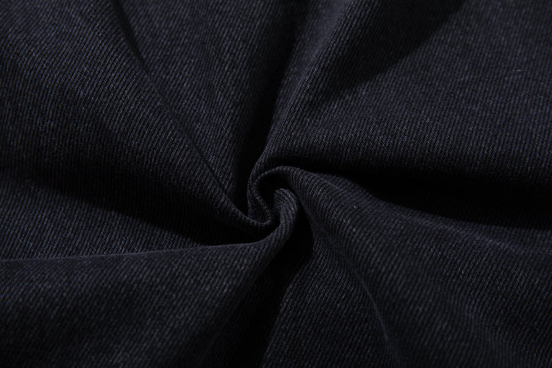 Close-up of washed black denim fabric texture