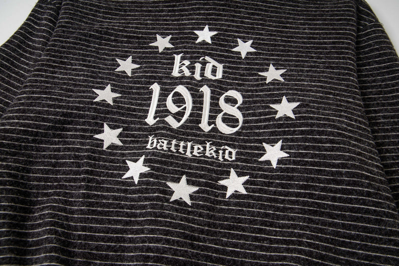 Close-up of black striped knit back graphic with stars and Battlekid 1918 text