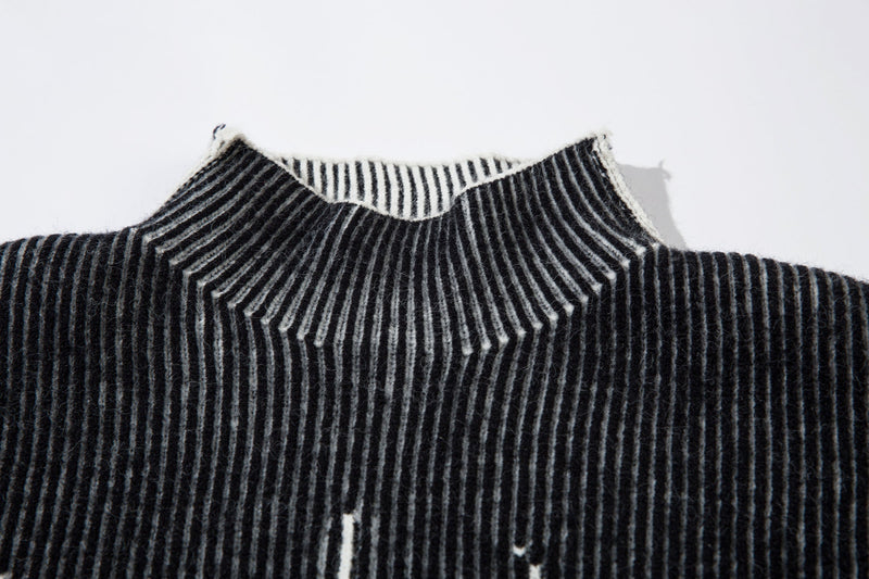 Close-up of black ribbed knit turtleneck with white striped inside collar