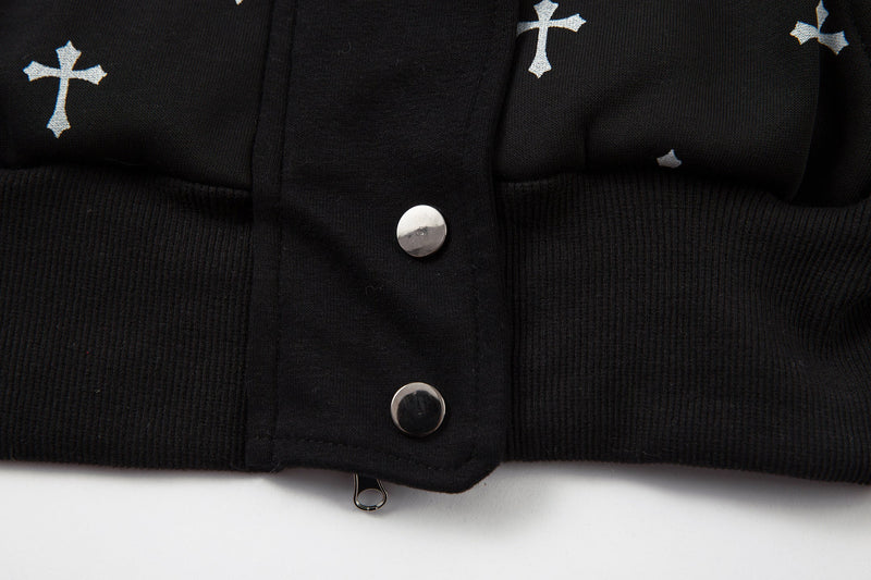 Close-up of black bomber jacket hem with snap buttons and cross print