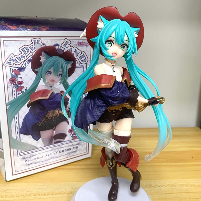 The Hatsune Miku Puss in Boots Fairy Tale 18cm PVC Figure, featuring a teal-haired anime character with fox ears, a red hat, and brown boots, stands on a white base. The blue and red outfit complements the dynamic persona showcased on its box.