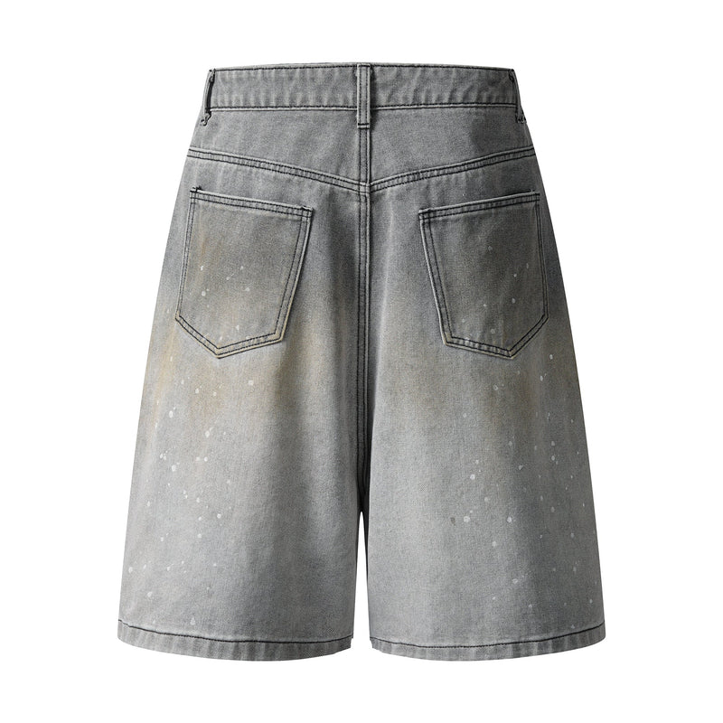 Back view of grey wash wide-leg denim shorts with speckled fading and patch back pockets