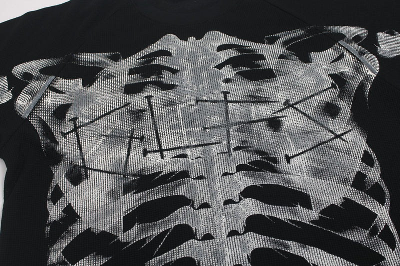 Black oversized tee with large distressed silver skeleton chest graphic in a cyber-grunge style