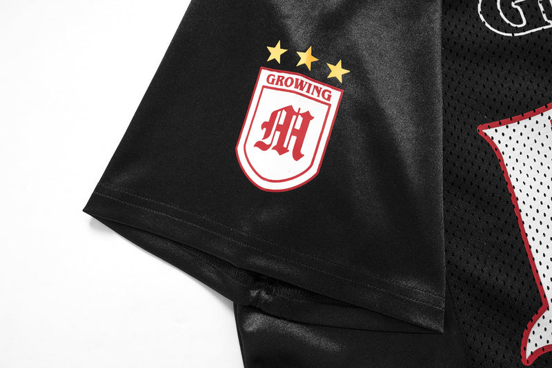 Black gothic mesh football jersey tee with red and white star crest and oversized streetwear details