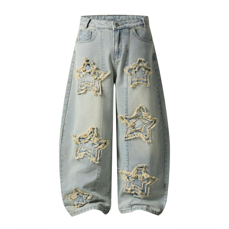 Front view of light wash wide-leg jeans with frayed star patches and distressed details