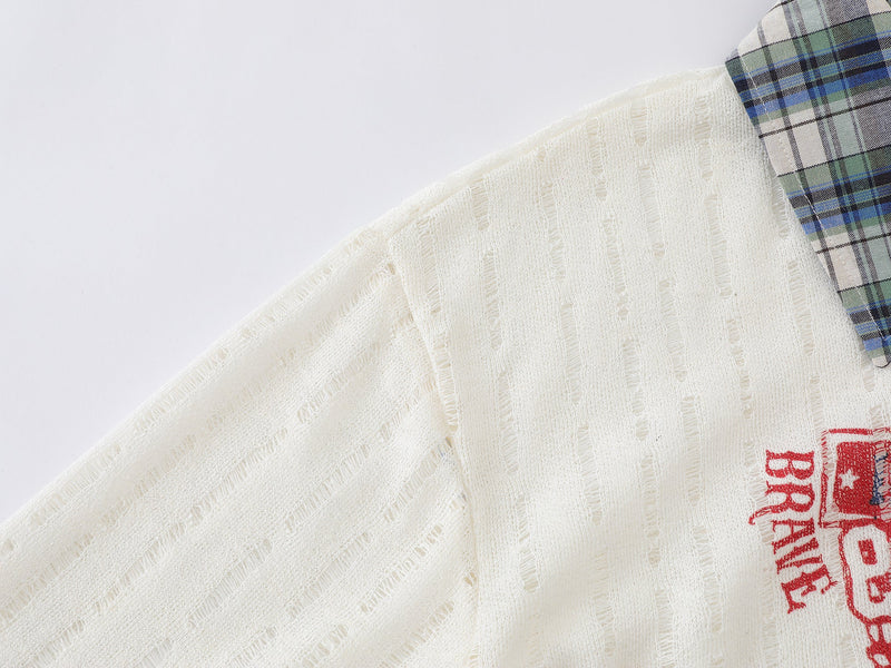 Close-up of cream distressed shirt shoulder and plaid collar detail with red graphic edge