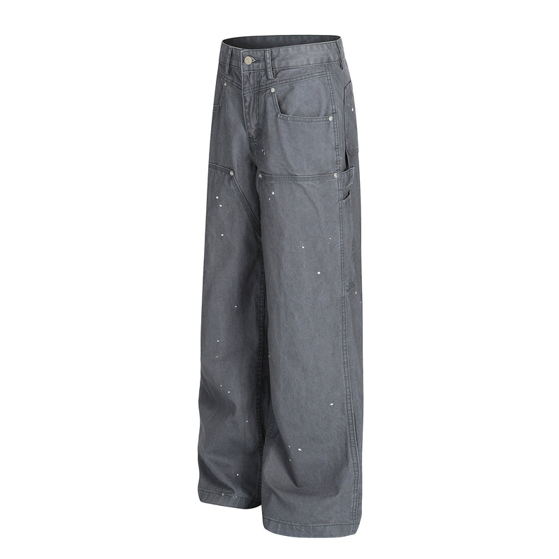 Gray wide-leg jeans with paint splatters, front view showing utility pockets and button fly