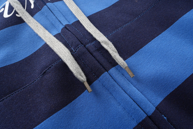 Close-up of gray drawstrings over blue and black striped hoodie front