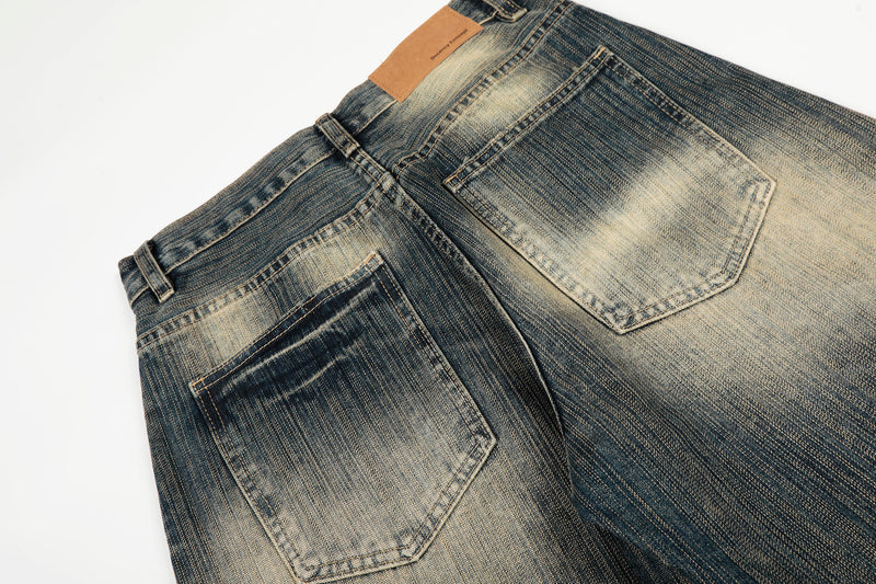 Close-up of the back waistband and patch pockets on washed wide-leg jeans