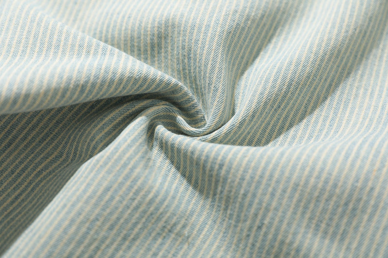 Close-up of striped denim fabric with soft folded texture