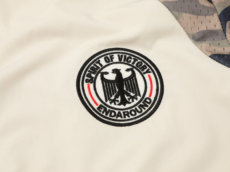 Cream button-up shirt with camo shoulder panel and embroidered Spirit of Victory eagle patch