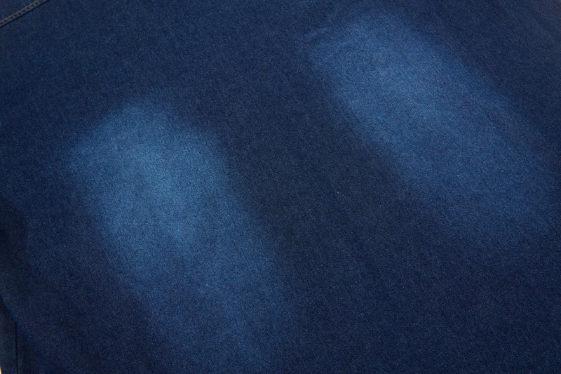Dark blue denim fabric with a faded wash, showing the textured material of a streetwear button-up shirt