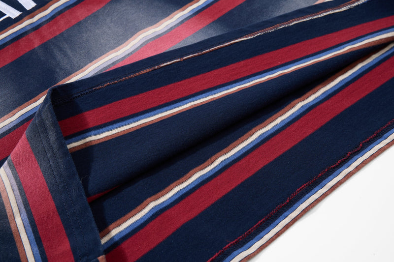 Close-up of striped fabric draped across the shirt with visible seam stitching