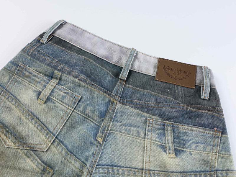 Back waistband detail showing brown patch label on faded blue denim jeans