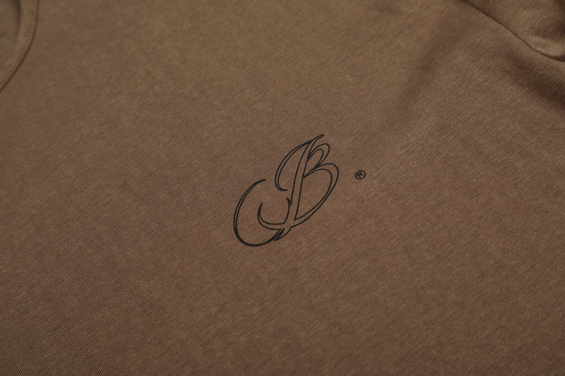 Close-up of brown T-shirt chest logo on soft cotton fabric