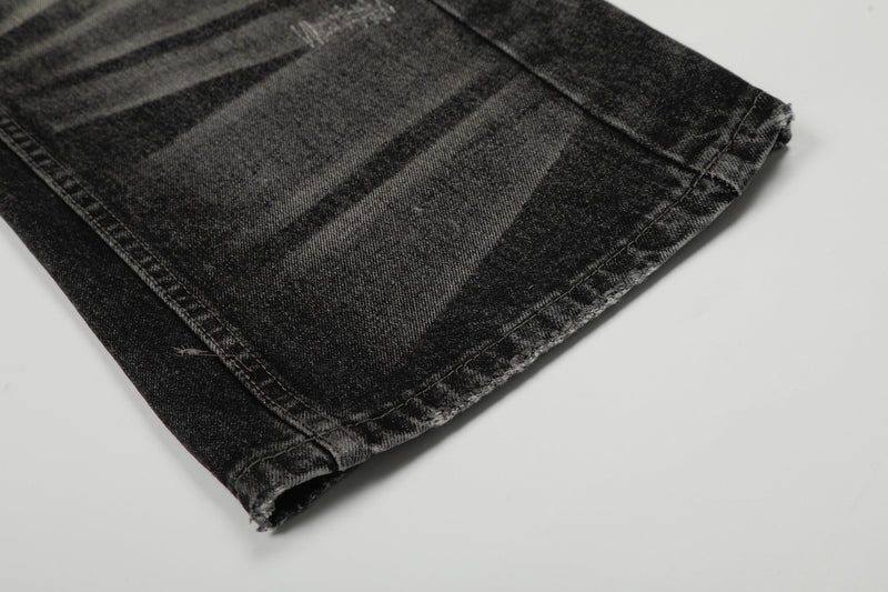 Close-up of frayed hem on black washed wide-leg denim pants