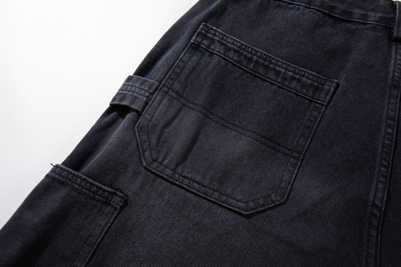 Close-up of side cargo pocket and stitching on washed black carpenter jeans