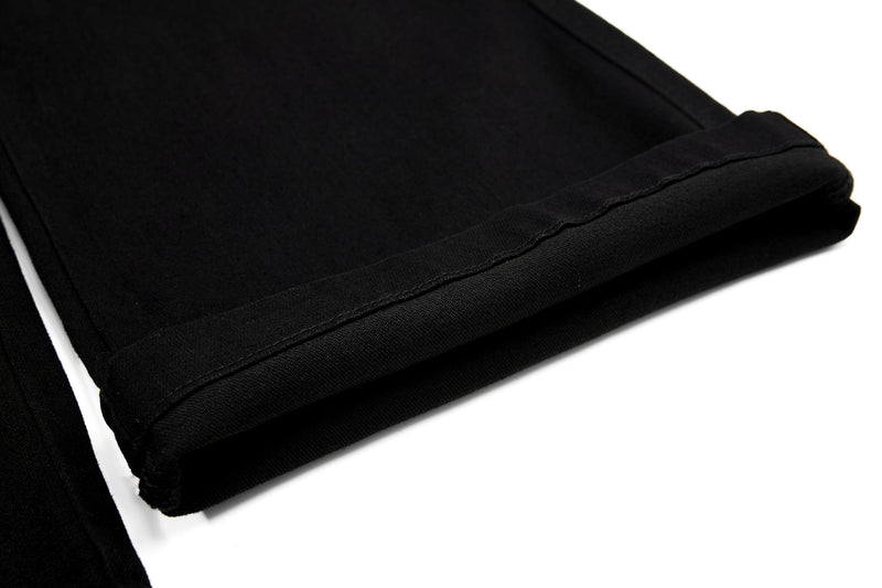 Close-up of folded black pant hem and stitched edge