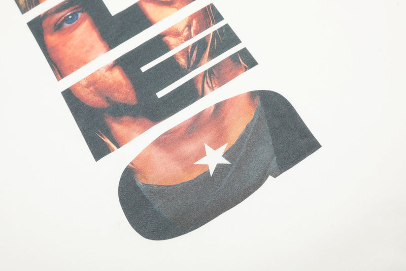 Close-up of lower front graphic with white star detail on a black and white raglan tee