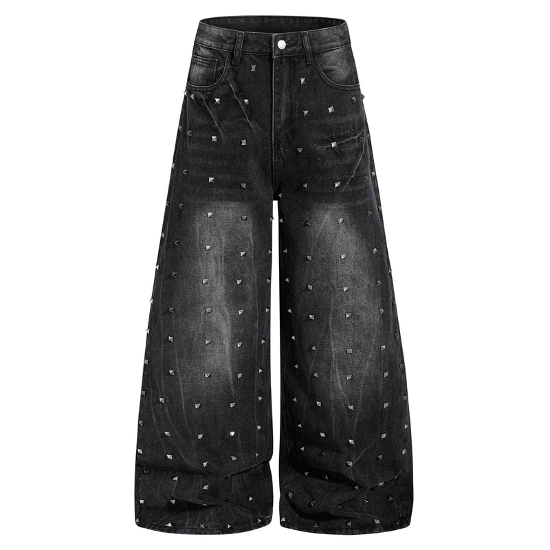 Front view of black wide-leg jeans with scattered silver pyramid studs