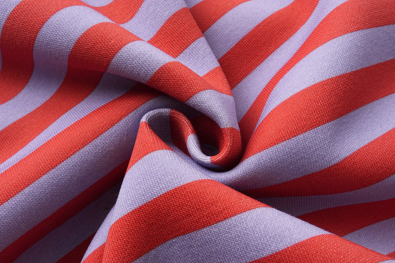Close-up of red and lavender striped fabric folds with soft texture