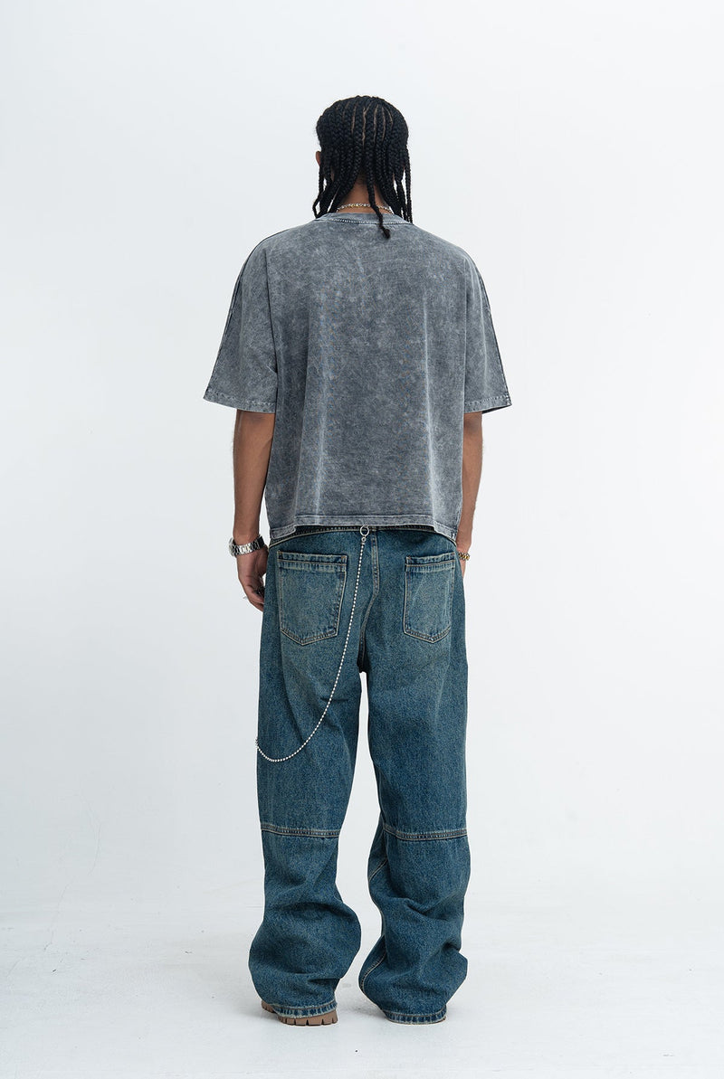 Vintage washed oversized gray goth rock graphic tee styled with baggy blue jeans and chain detail, back view