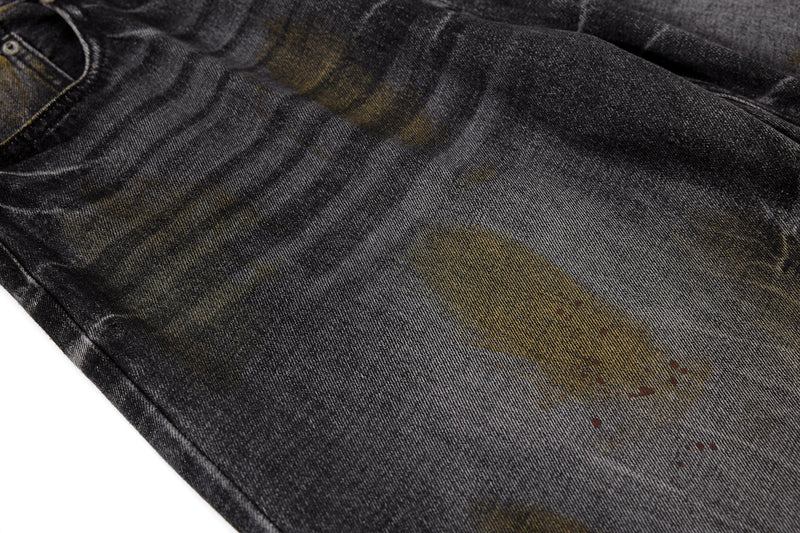 Close-up of black denim leg panel with faded vintage wash marks