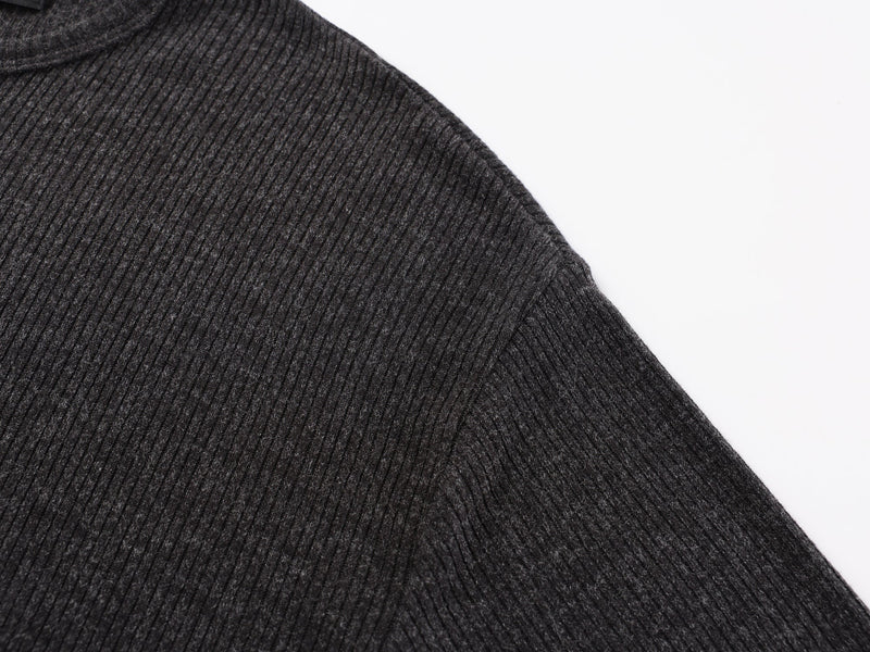 Close-up of black ribbed shoulder and sleeve seam