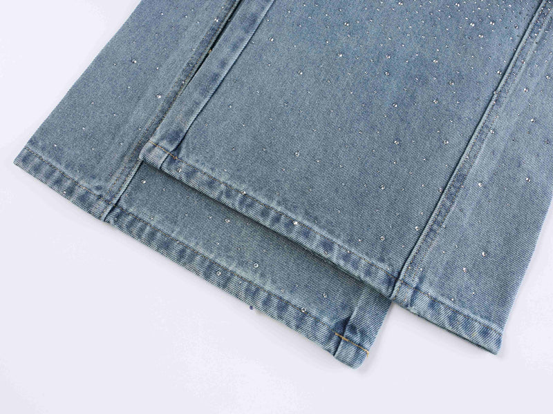 Light blue denim hem close-up with rhinestone speckles and folded cuff