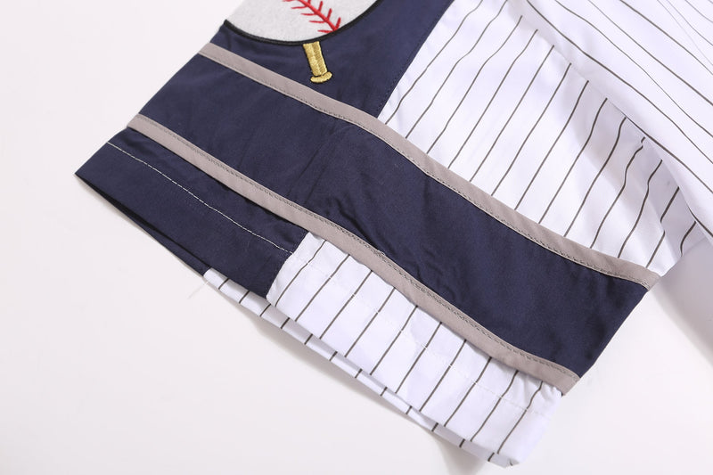 Close-up of sleeve hem with navy panel, gray trim, and white pinstripes