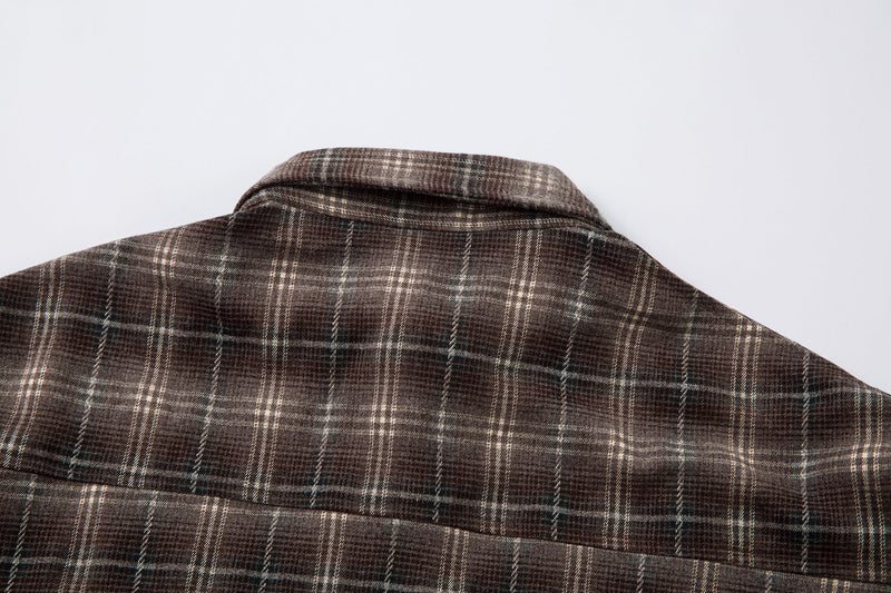 Close-up of back yoke and collar on brown plaid shirt